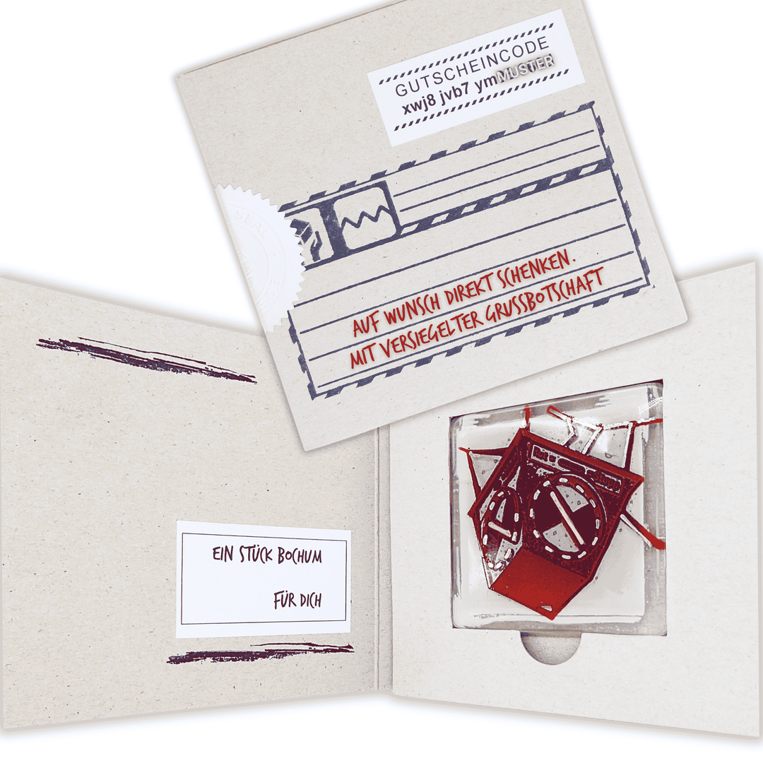 Edition 0/12. Offene und versiegelte Pott Glas Gutschein-Verpackung mit der Aufschrift „Auf Wunsch direkt schenken. Mit versiegelter Grußbotschaft.“ Gezeigt wird das rote Heuer-Ampel-Motiv als Muster.