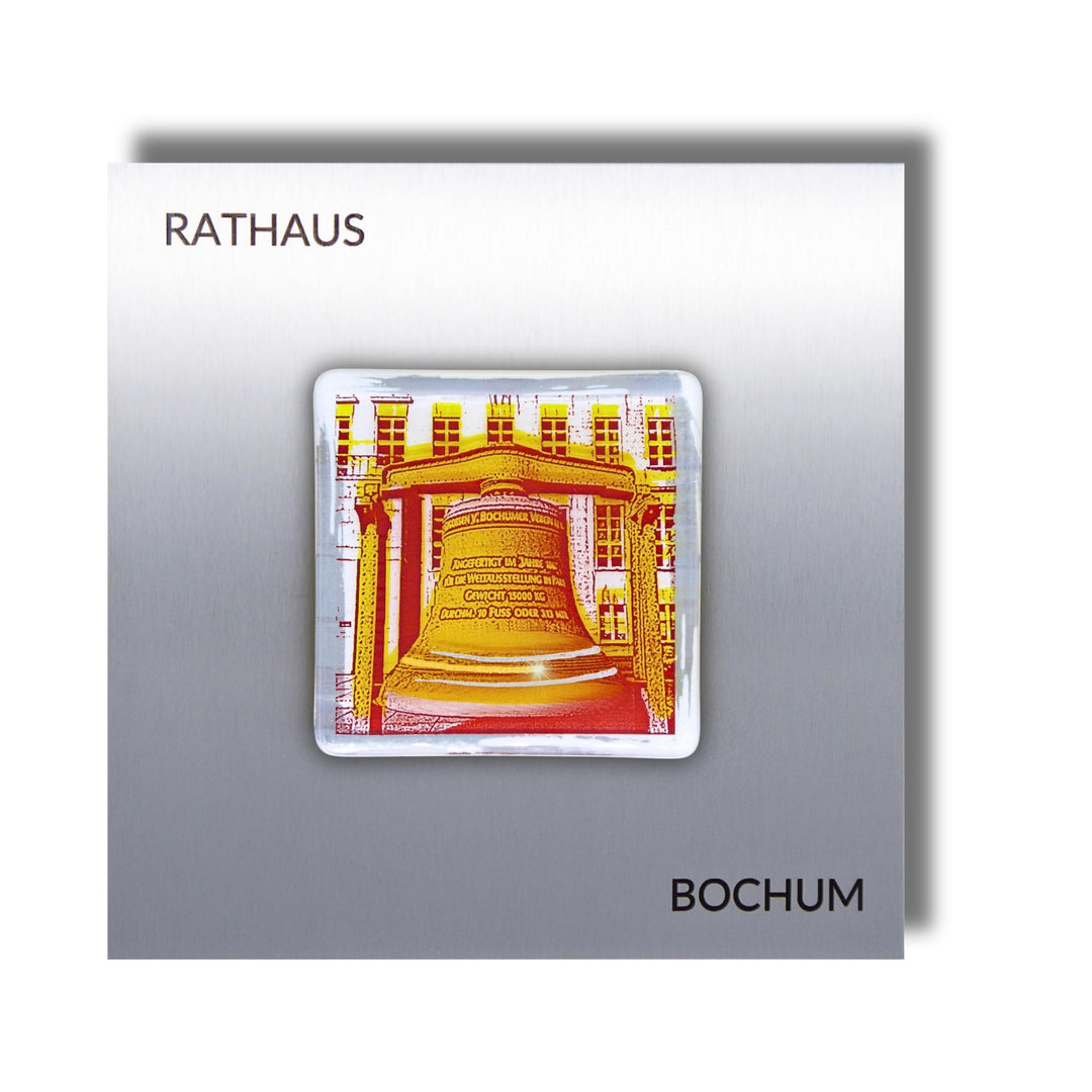 Edition 12/12. Pott Glas Wand-Potträt mit Rathausglocke-Motiv in Gelb. Foto in Schmelzglas auf Edelstahl. Quadratisches Format mit Gravur „Rathaus Bochum“.