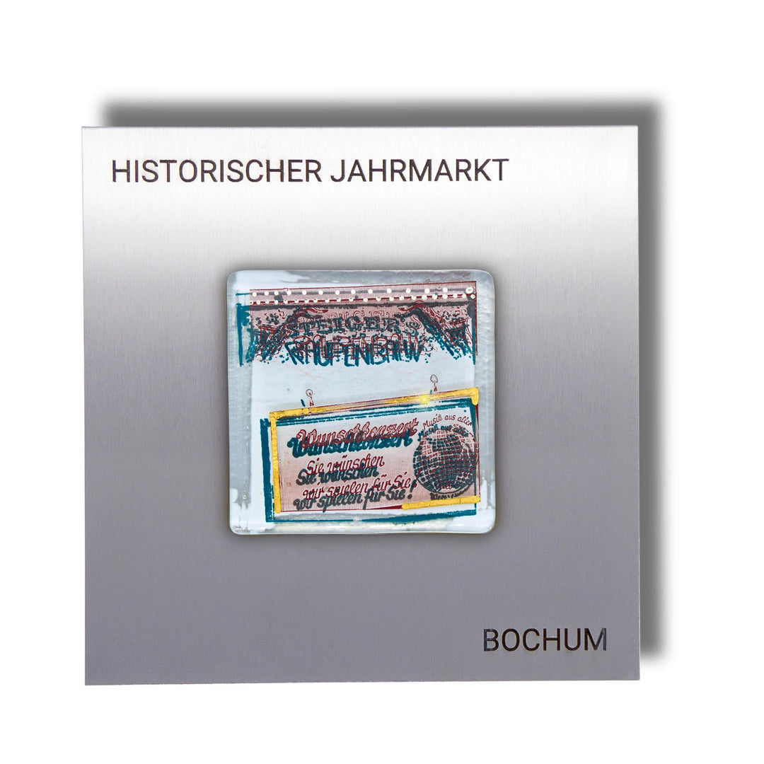 Edition 3/12. Pott Glas Wand-Potträt mit "Raupenbahn"-Motiv in Grün, mit Gold und Platin Akzenten. Foto in Schmelzglas auf Edelstahl. Quadratisches Format mit Gravur „Historischer Jahrmarkt Bochum“.