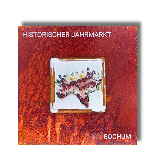 Edition 3/12. Pott Glas Wand-Potträt mit "Looping the Loop"-Motiv in Grün. Foto in Schmelzglas auf Roststahl. Quadratisches Format mit Gravur „Historischer Jahrmarkt Bochum“.