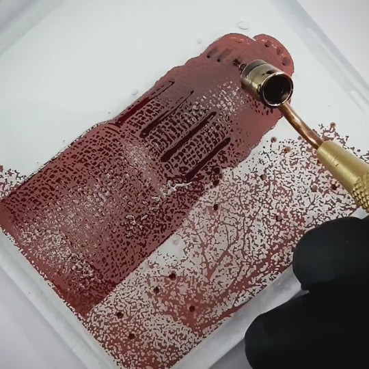 Pott Glas Produktvideo. Zeigt das manuelle Setzen von Akzenten am „Stadtpark“-Glasbild mit Flüssiggold und Platin.